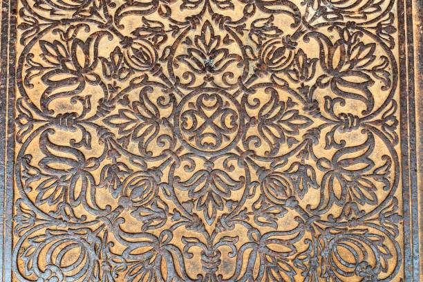 istock Russia, Rostov, July 2020. Old cast-iron floor slab with a floral pattern. 1293736156