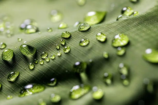 waterproof fabric - closeup of water resistant clothing textile with water drops