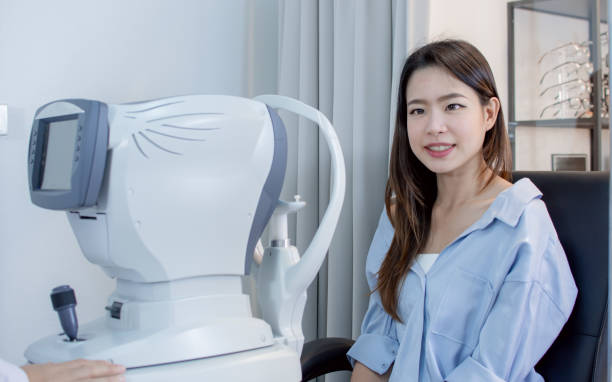 istock woman doing eyes test in optical lab. 1293737024