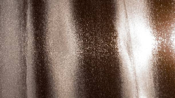 istock Brown fabric against the light with colored spots. 1293738156