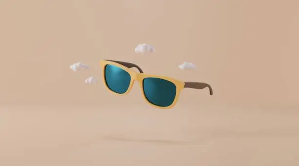 Photo of yellow sunglasses isolated on yellow background.