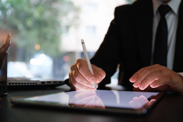 デジタルタブレットで電子法的文書に署名するビジネスマン - digital tablet digitized pen touchpad men ストックフォトと画像