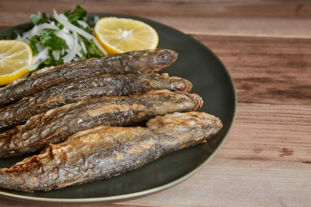 istock Blue fish with lemon slices and onion salad 1293740349