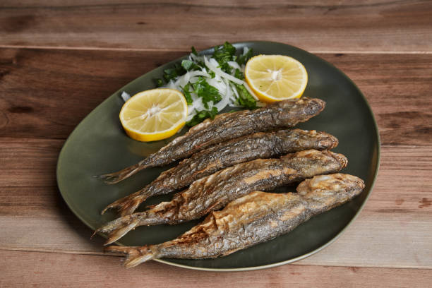 istock Blue fish with lemon slices and onion salad 1293740361