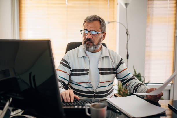 istock An older businessman in his office 1293742135