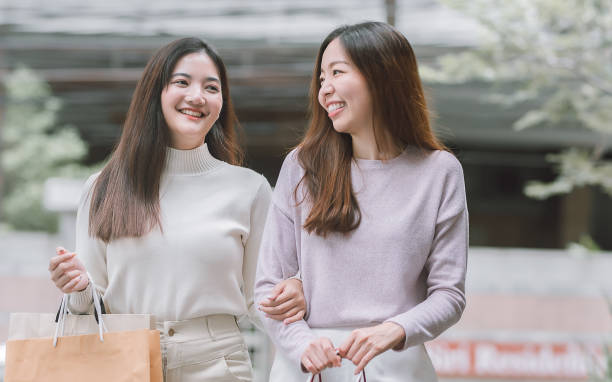istock Two asian women doing window shopping together 1293744393
