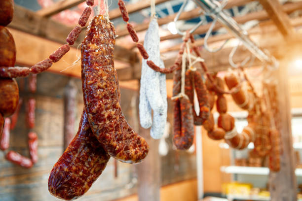istock Many smoked sausages hanging on the ropes 1293745509