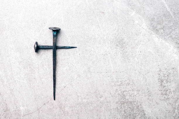 Cross made with rusty nails and drops of blood on grey background. Copy space. Good Friday, Easter day. Christian backdrop. Biblical faith, gospel, salvation concept. Crucifixion of Jesus Christ stock photo