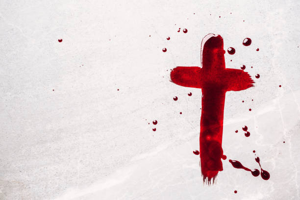 Christian cross painted with red blood on stone background. Copy space. Good friday. Passion, crucifixion of Jesus Christ. Christian Easter holiday. Crucifix, gospel, salvation concept stock photo