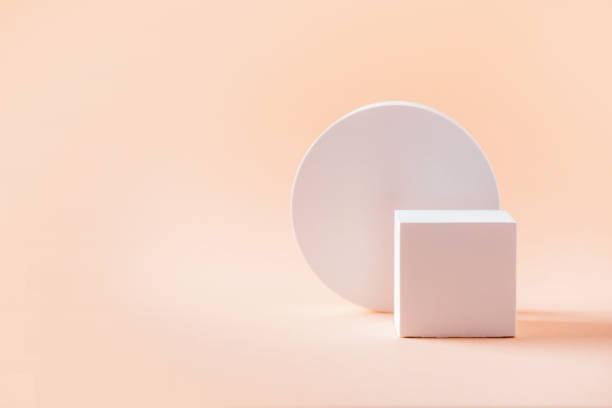 istock White geometric shapes podium for product display on beige background. Monochrome stage, stand for product promotion in minimal style. Copy space for your design. Banner 1293749430