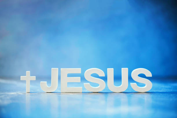 Name JESUS made with cement letters on blue light marble background. Copy space. Biblical, spiritual or christian reminder.