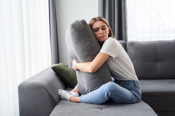istock Woman hugging big pillow 1293751425