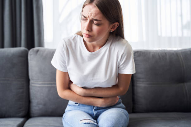 istock Sad woman suffering from menstrual cramps 1293751441