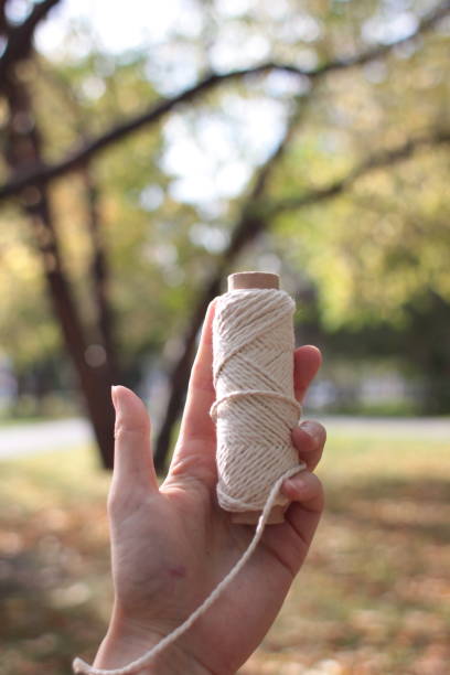 istock Skein of threadin girl hand 1293751725