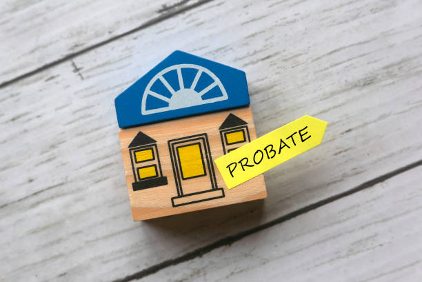 Probate Top view of toy wooden house and sticky note written with Probate on white wooden background. probate stock pictures, royalty-free photos & images