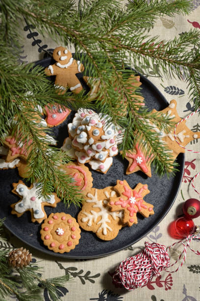 istock Gingerbread Christmas Cookie on Plate and Pine Brunches 1293752726