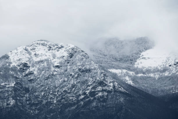 istock View from above, stunning panoramic view of a snow capped mountain range during a cloudy day. Italy 1293754956
