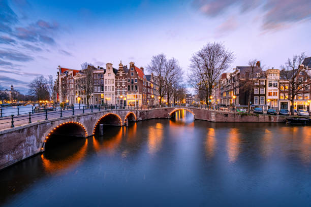 istock Amsterdam Netherlands during sunset, historical canals during sunset hours 1293756123