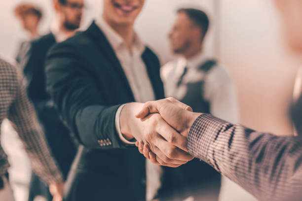 istock close up. young casual business people shaking hands with each 1293756232