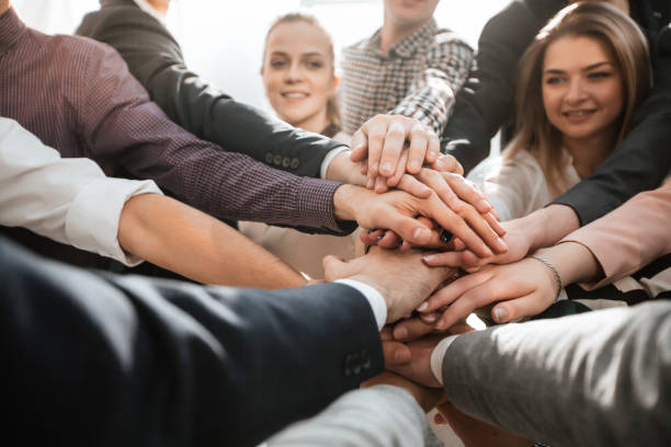 istock close up. a group of diverse young people showing their unity 1293756832