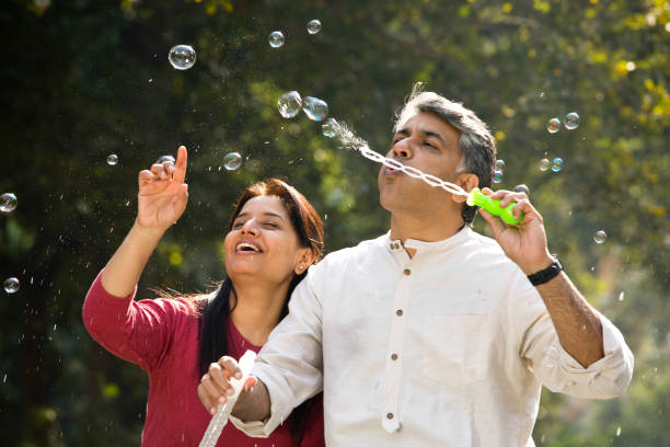 istock Couple blowing bubbles at park 1293757457