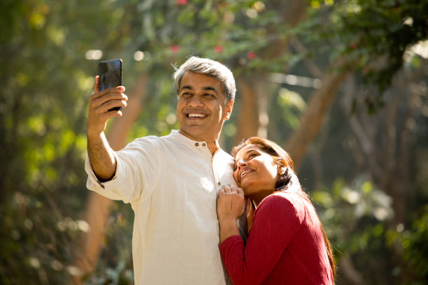 istock Loving couple taking selfie at park 1293757610
