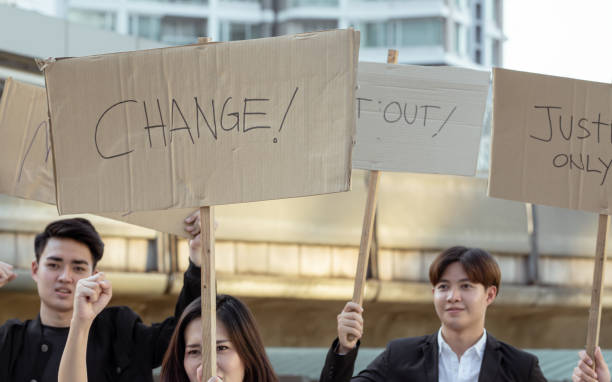 istock Protesters with signs of change and justice 1293757678
