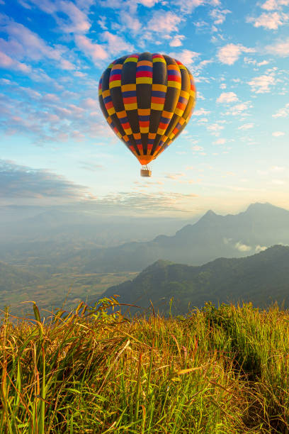 istock Mountain scenery with hot air balloons and beautiful sky 1293757737