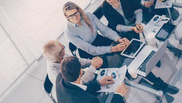 istock top view. business colleagues discussing business documents 1293758532