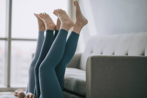 istock asian chinese legs with yoga pants resting on sofa 1293758956