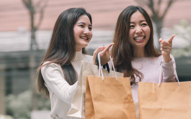 istock Two asian women doing window shopping together 1293761639