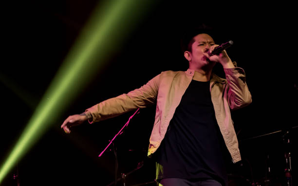 istock Asian male singer showing his performance on stage 1293762596