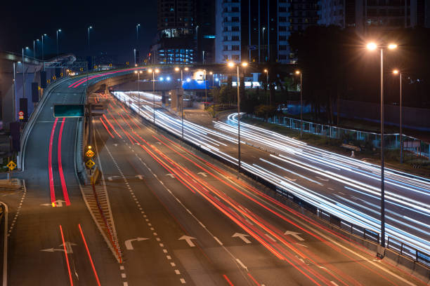 istock light trail of busy highway on both way 1293763636