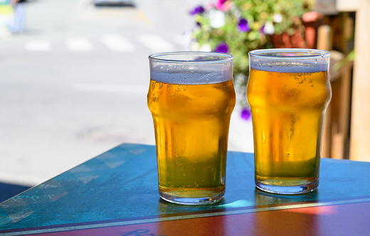 French cold beer in misted glasses served on outdoor terrace in small Alpine village in France close up