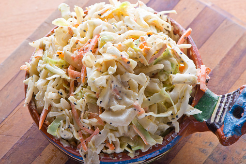 Coleslaw. BBQ or steakhouse side dish favorite. Coleslaw made with shredded cabbage, onions, carrots, dill, salt and pepper and mixed with homemade mayo. Classic American or BBQ restaurant favorite.