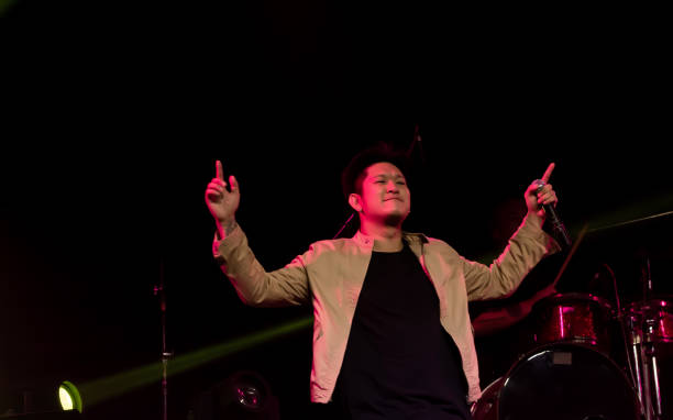 istock Asian male singer showing his performance on stage 1293766524