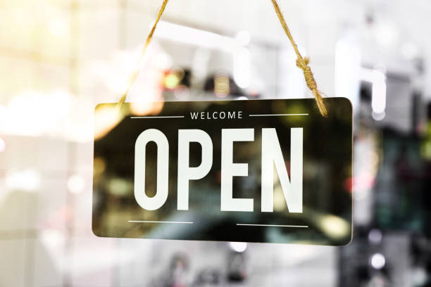Open sign board hang on glass of door  in cafe Open sign board hang on glass of door  in cafe open sign stock pictures, royalty-free photos & images