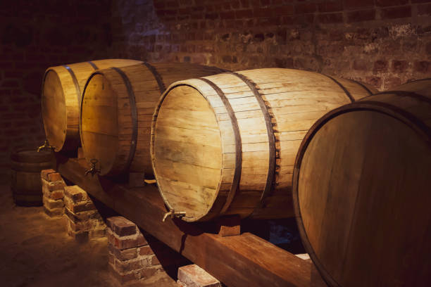 istock Old oak barrels for wine in the basement. Winemaking. 1293767651