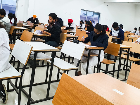 December 8, 2020.Lucknow Uttar Pradesh,India. West Bengal India. Medical students writing examination paper in mask maintaining social distancing at Radheshwam Medical College,Lucknow, UP, India.