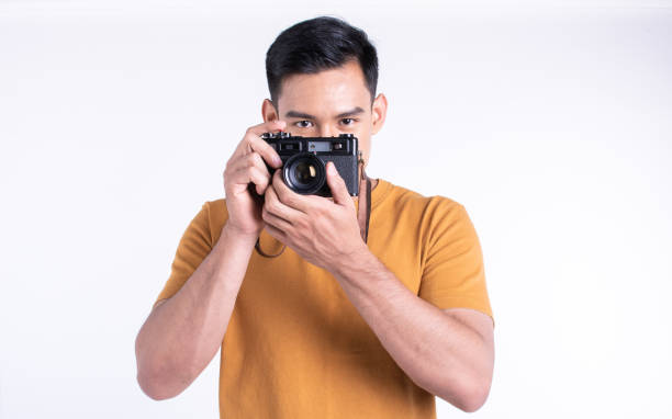 istock Asian man holding camera for traveling and standing on white background 1293770543