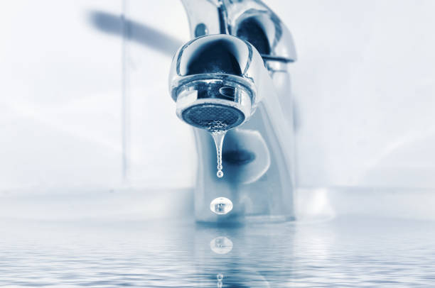 istock Faucet and water drops close up 1293770745