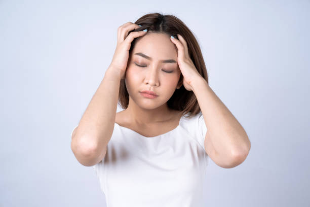 istock Beautiful young asian touching her temples feeling stress, Isolated on white background. 1293771907