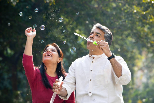 istock Couple blowing bubbles at park 1293772606