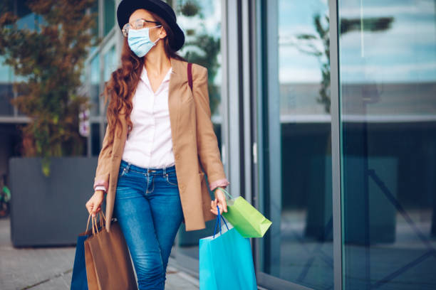 istock Beautiful woman wearing protective face mask in shooping 1293772619