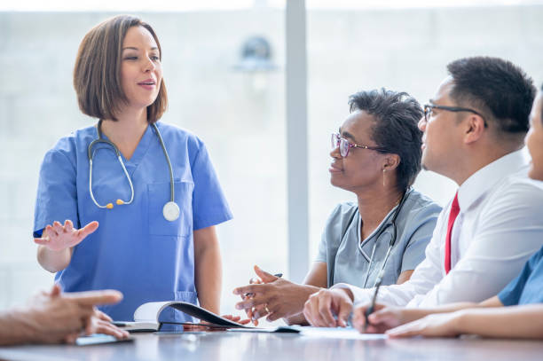 istock Healthcare workers meeting together 1293772848