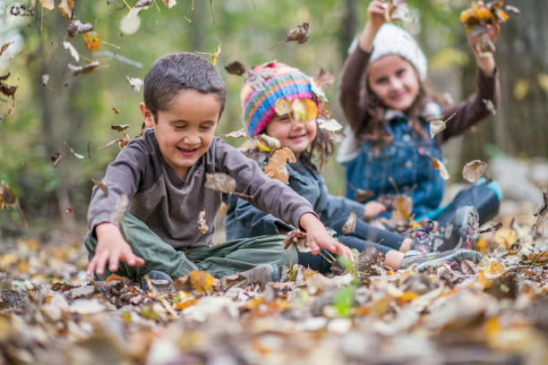 istock Siblings enjoying the Autumn leafs together 1293775257