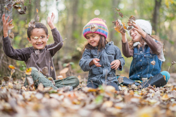 istock Siblings enjoying the Autumn leafs together 1293775265