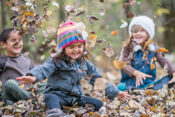istock Siblings enjoying the Autumn leafs together 1293775268