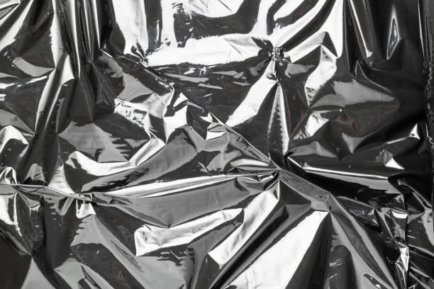 istock Plastic bag texture. Wrap transparent dark cellophane background. Black shiny film pattern for packaging, product protection. 1293778164