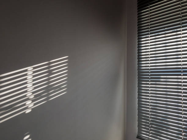 istock Lights shadows. Abstract light, black shadow overlay from window on white texture wall. Sunlight architecture background. Textures Light reflection from the window. 1293781167